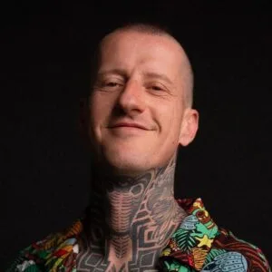 Tattoo artist Kubec WT headshot portrait with neck tattoo artwork